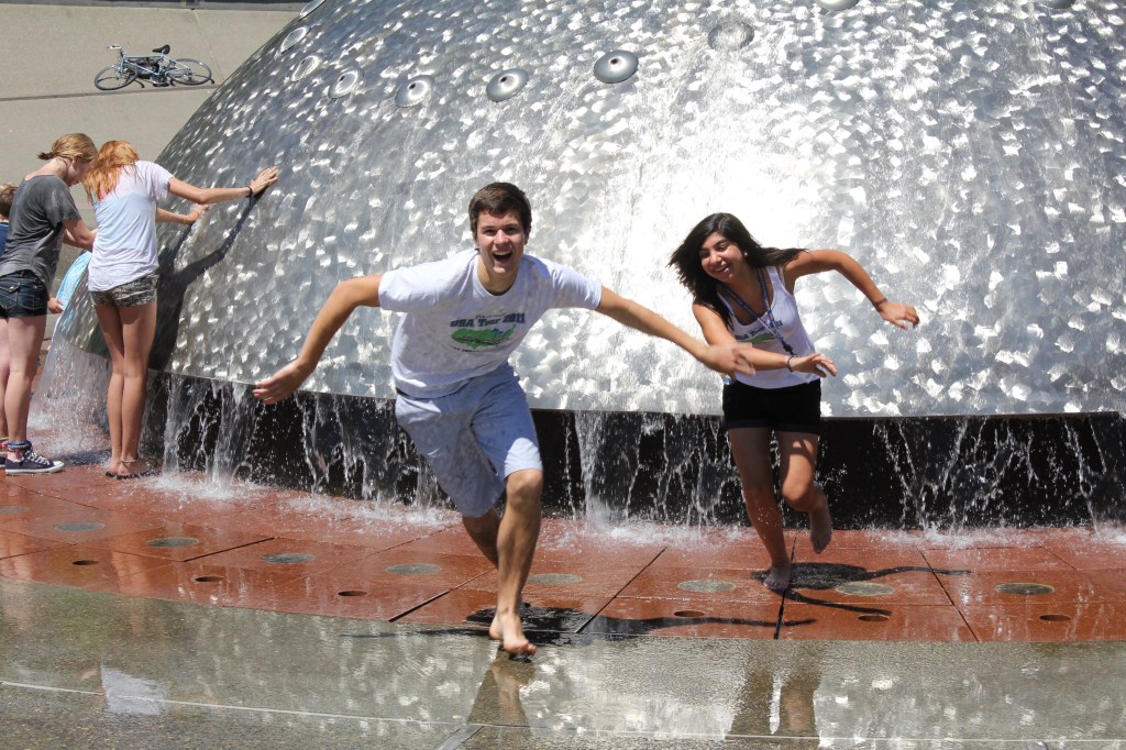 Two students playing in a fountain.